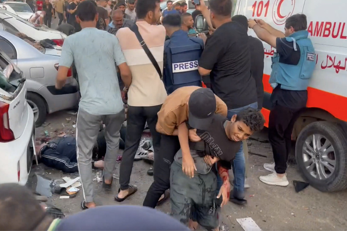 A screen grab captured from a video shows people help injured ones following the Israeli attacks on the entrance of the Al-Shifa Hospital in Gaza City, Gaza on November 3, 2023 [AA - Anadolu Agency]