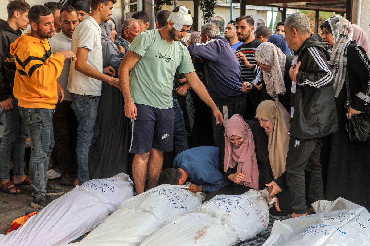 People mourn next to dead bodies of Palestinians, who lost their lives during the Israeli attacks as they take out the bodies from the Al-Najjar Hospital, to perform funeral prayers in Rafah, Gaza on October 17, 2023 [Abed Rahim Khatib - Anadolu Agency]