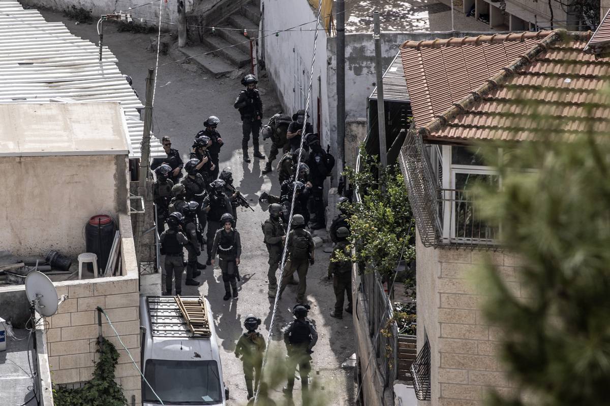 Israeli forces take security measures during the demolition process of Palestinian Hayri Alkam's house using explosives as they raid Silwan district of East Jerusalem on November 15, 2023 [Mostafa Alkharouf - Anadolu Agency]