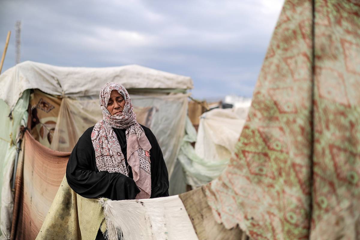 A woman is seen amid tents set up in the United Nations Relief and Works Agency (UNRWA) refugee camp located in Khan Yunis, Gaza where displaced Palestinian families take shelter and try to maintain their daily lives under harsh conditions amid the Israeli attacks on Gaza, on November 15, 2023 [Belal Khaled - Anadolu Agency]