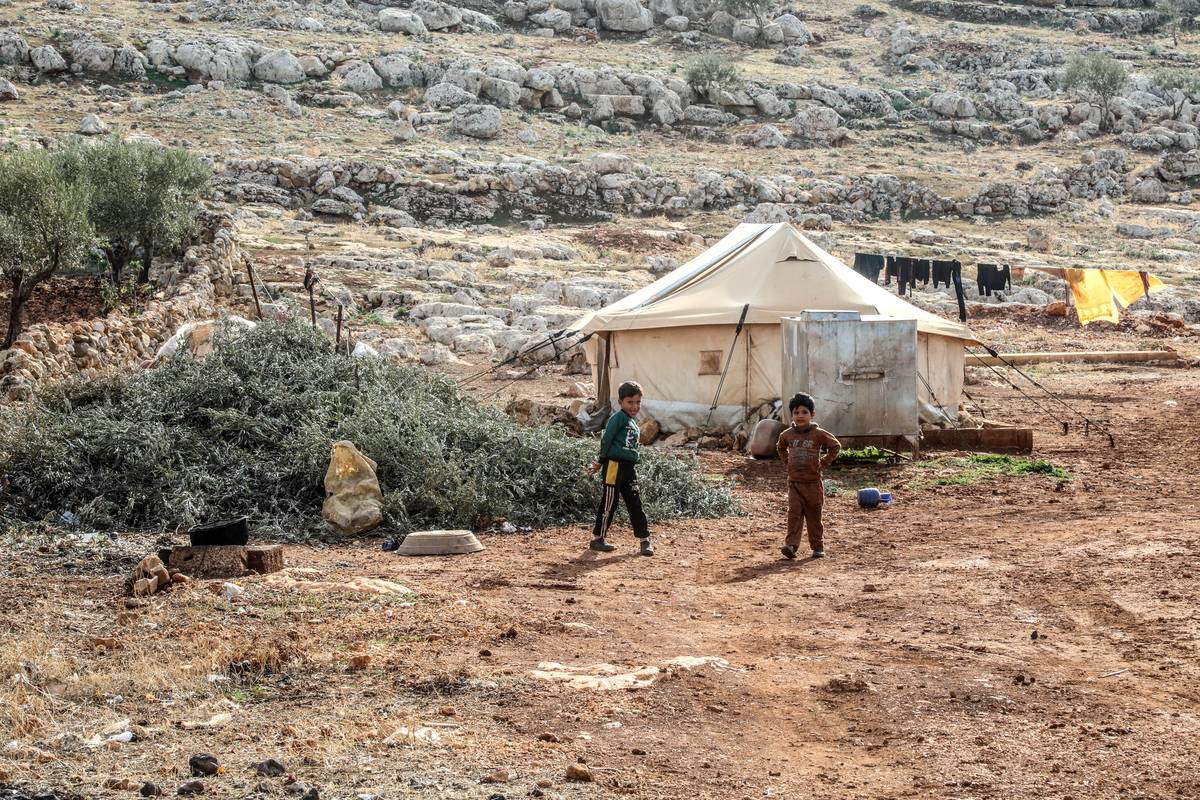 Children play games as Syrian refugees struggle with cold weather while winter approaches in Idlib, Syria on November 22, 2023 [İzettin Kasım - Anadolu Agency]