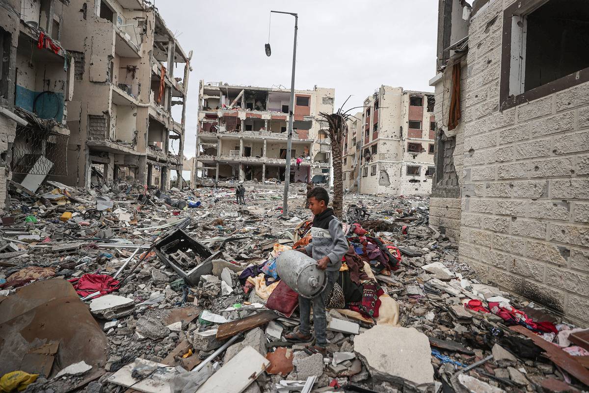 A child is seen among the rubble in the residential area known as Juhor ad-Dik, built by the Turkish Cooperation and Coordination Agency (TIKA) and heavily damaged due to Israeli attacks in the southeastern part of the enclave of Gaza Strip on November 28, 2023 [Mustafa Hassona - Anadolu Agency]