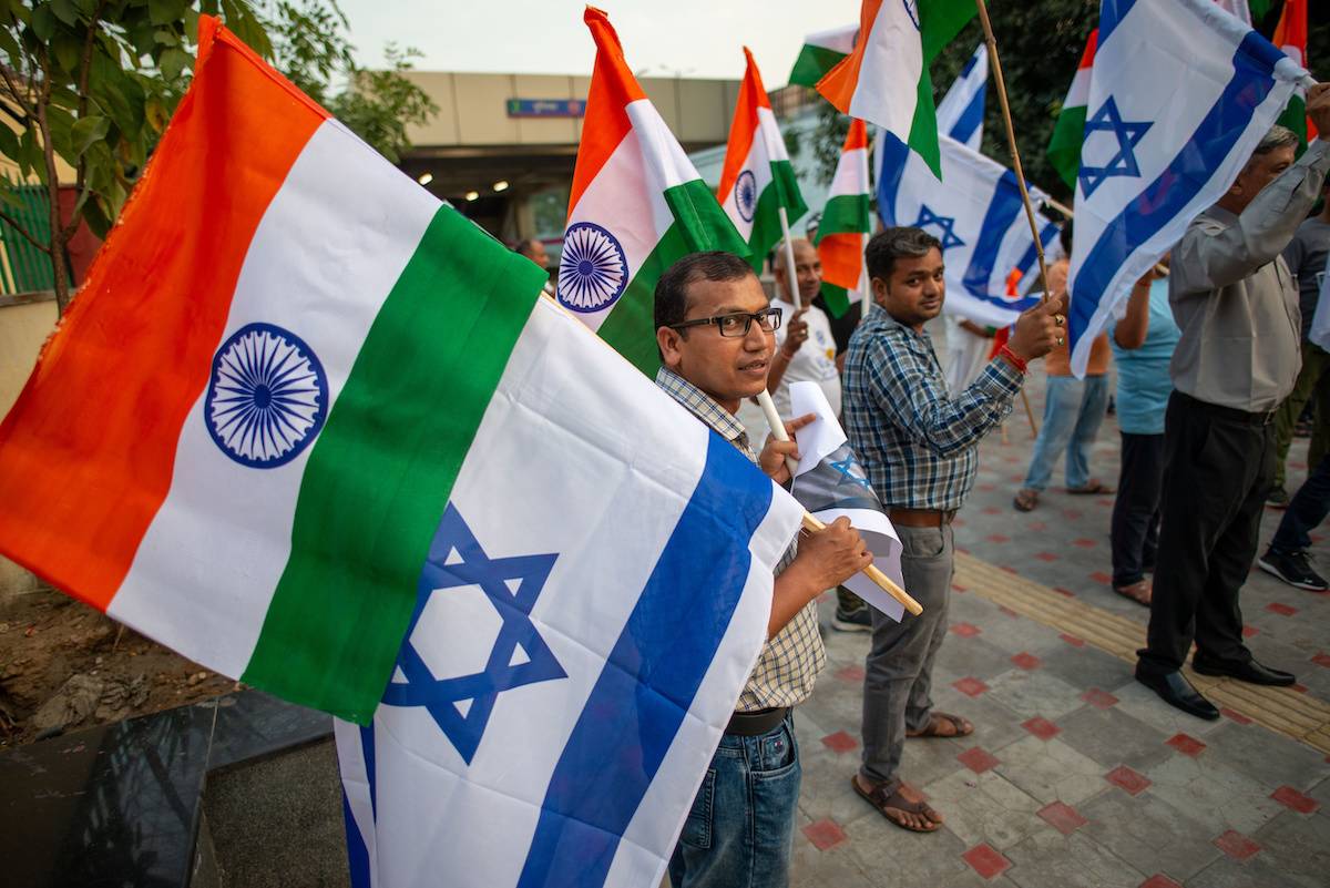 Supporter of the BJP (Bharatiya Janata Party, India's ruling party) holding flags expressing their opinions during a protest to show solidarity with Israel, on 15 October 2023, in New Delhi, India [Pradeep Gaur/SOPA Images/LightRocket via Getty Images]