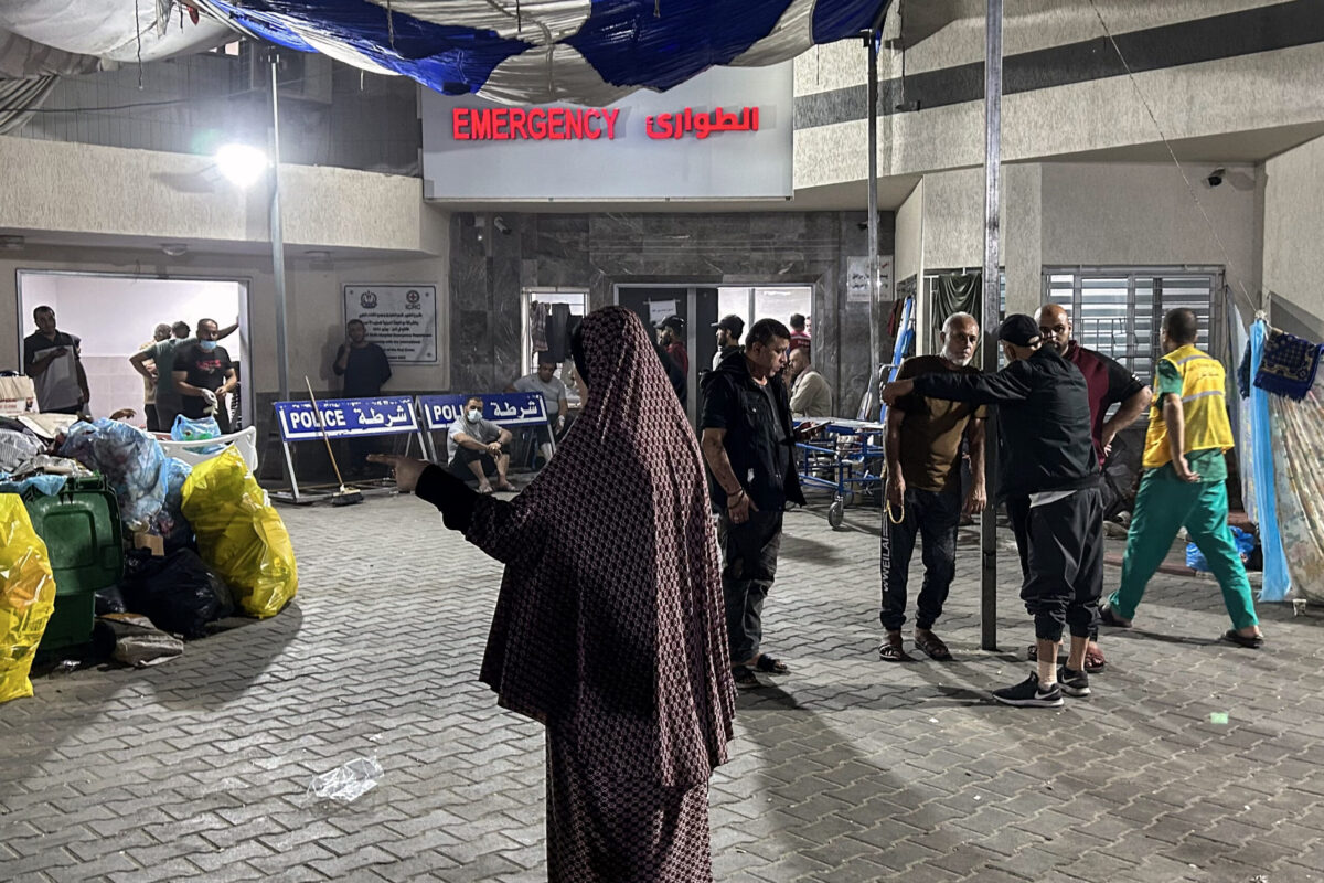 People stand outside the emergency ward of Al-Shifa hospital in Gaza City on November 10, 2023 [KHADER AL ZANOUN/AFP via Getty Images]