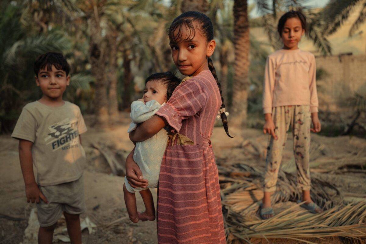 Wassan, 9, and her siblings on the land her family used to cultivate before the drought in Abu Al-Khasseb, Basra Governorate, Iraq [Emily Garthwaite/Save the Children]