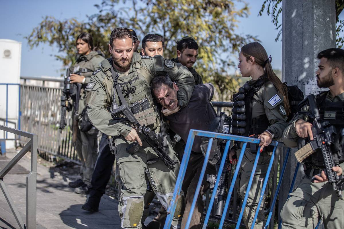 Israeli forces take a Palestinian into custody as they intervene in Palestinians gathering at Wadi al-Joz neighborhood to perform Friday prayer in East Jerusalem on December 01, 2023. [Mostafa Alkharouf - Anadolu Agency]