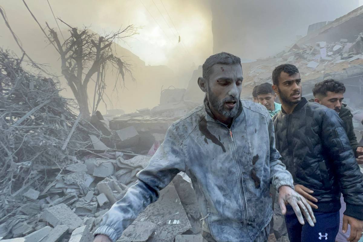 A wounded man walks away after the Israeli airstrikes hit a residential building and caused casualties in Tal al-Zaatar area, northern Gaza on December 03, 2023 [Fadi Alwhidi - Anadolu Agency]