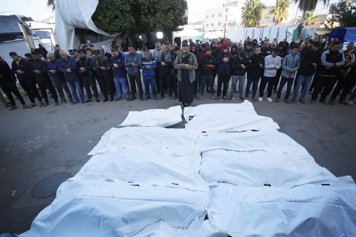 Palestinians perform funeral prayer at Al-Aqsa Martyrs Hospital for those who lost their lives during Israeli attacks on the Nasirat Refugee Camp in Deir Al Balah, Gaza on December 03, 2023 [Ashraf Amra - Anadolu Agency]