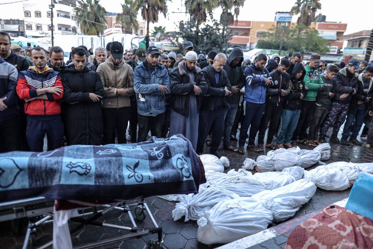 Relatives of Palestinians killed in Israeli attacks perform prayer after taking from Al-Aqsa Martyr's Hospital's morgue for funeral ceremony in Deir al-Balah, Gaza on December 13, 2023 [Ali Jadallah/Anadolu Agency]