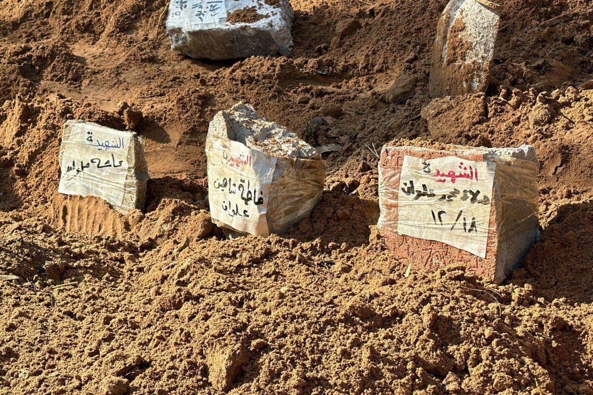 Bodies of Palestinians killed in Israeli attacks are buried in mass graves as more than 100 have been killed in the recent attacks on Jabalia refugee camp in Jabalia, Gaza on December 18, 2023 [Abdulqader Sabbah/Anadolu Agency]