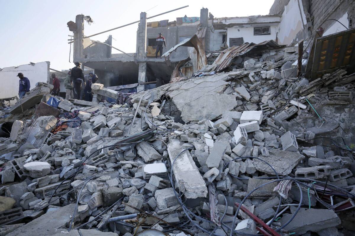 Palestinians try to collect usable items among debris of a destroyed building after Israeli attacks in Deir Al Balah, Gaza on December 19, 2023 [Ashraf Amra - Anadolu Agency]