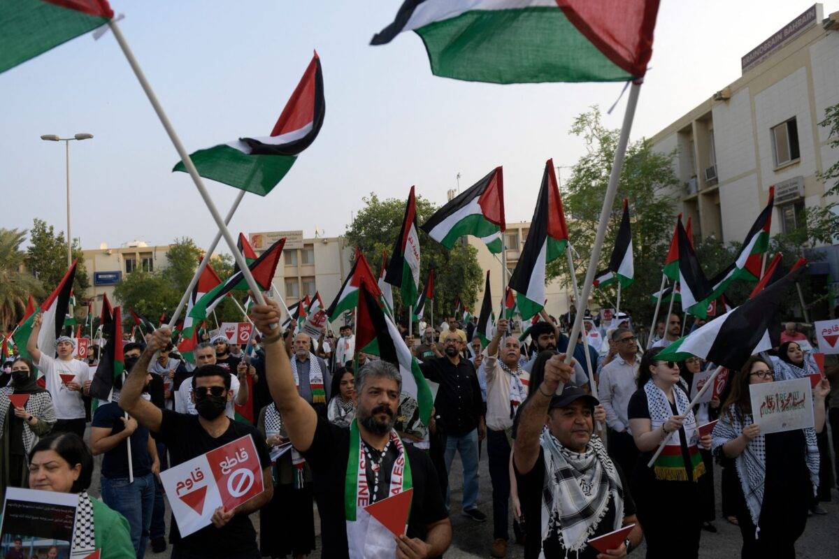 Protesters wave Palestinian flags during a solidarity sit-in with the Gaza Strip, in Manama on November 17, 2023 [MAZEN MAHDI/AFP via Getty Images]