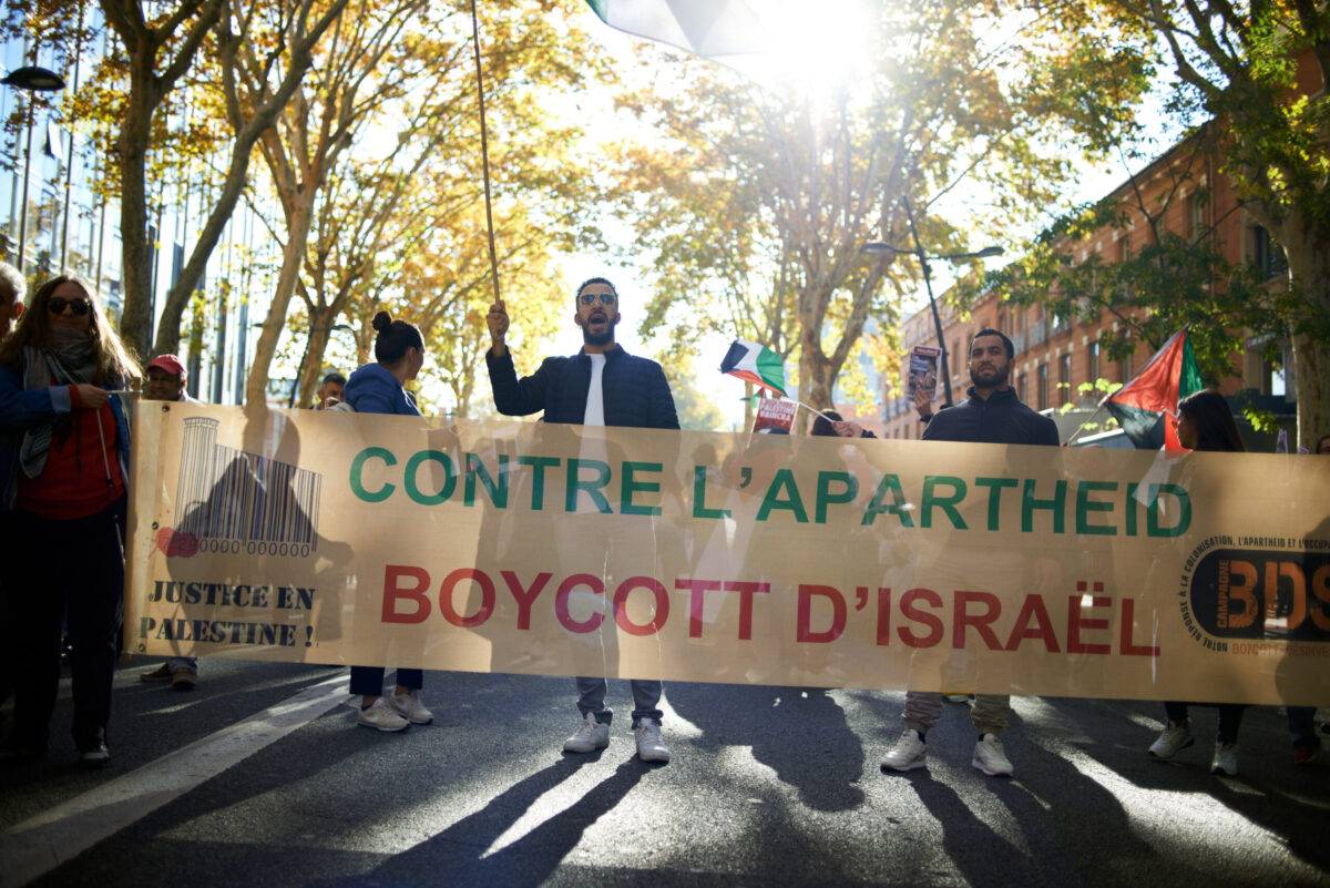 A banner reads 'Against apartheid, Boycott of Israel'. Thousands of people demonstrate in support of Gazans, in Toulouse France on November 18th 2023 [Alain Pitton/NurPhoto via Getty Images]