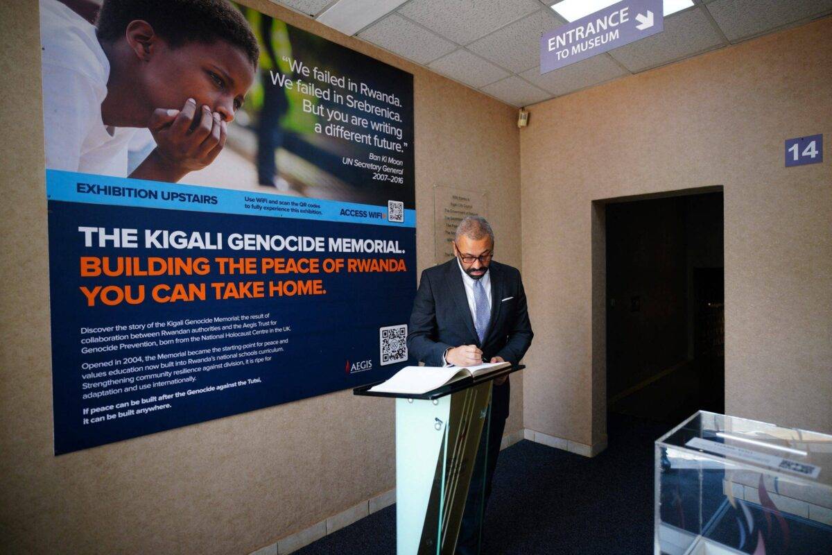 Britain's Home Secretary James Cleverly signs a guestbook during a visit to the Kigali Genocide Memorial on December 5, 2023 [BEN BIRCHALL/POOL/AFP via Getty Images]