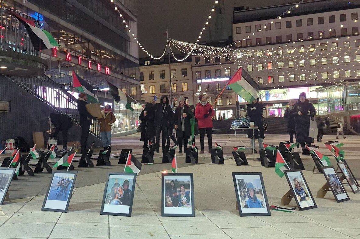 Protestors gather around an exhibition featuring the photographs of children and journalists killed in Israeli attacks on Gaza despite the cold weather at Torg Square in Stockholm, Sweden on December 14, 2023. [Atila Altuntas/Anadolu via Getty Images]