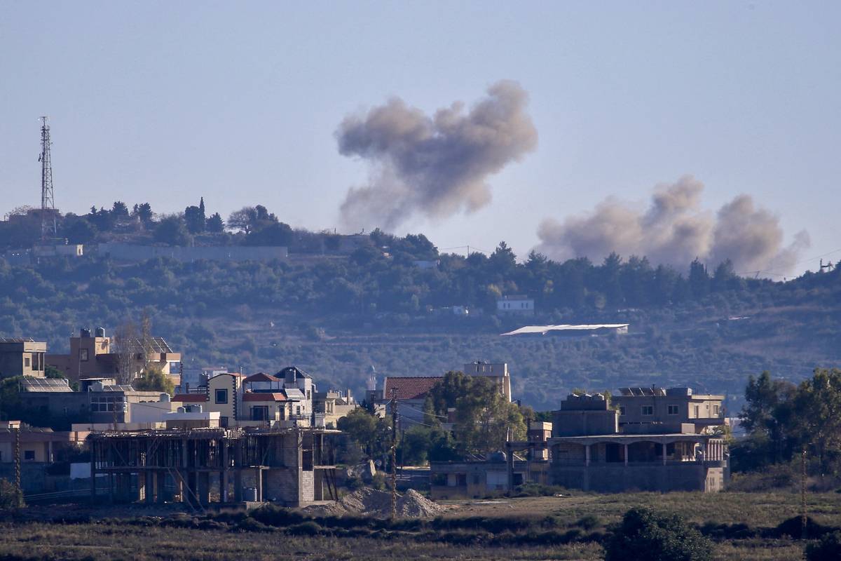 A picture taken from from the southern Lebanese village of Tayr Harfa, near the border with Israel shows smoke billowing near an Israeli outpost from rockets fired by Hezbollah on December 15, 2023. [Photo by -/AFP via Getty Images]