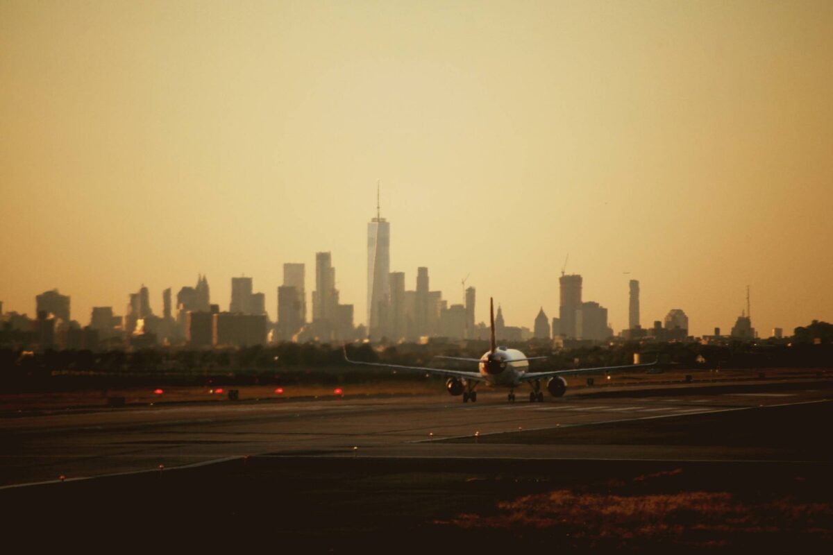 NYC skyline view from airport with airplane taking off [Getty]