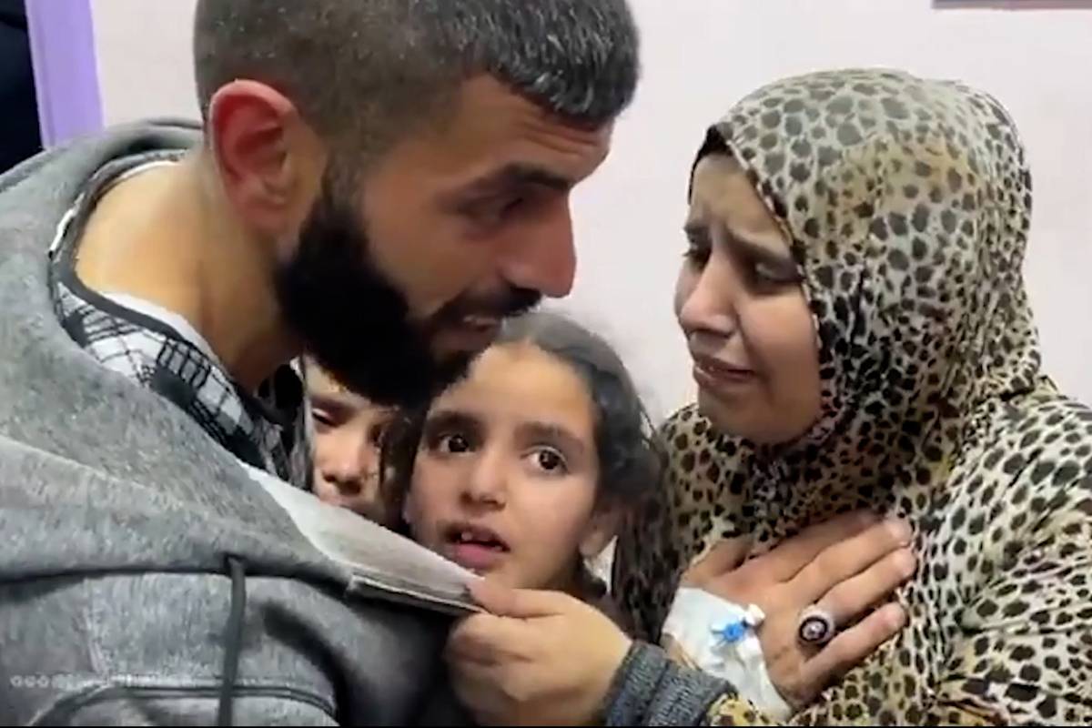 Gaza paramedic consoles his kids after Israeli air strike destroyed their home