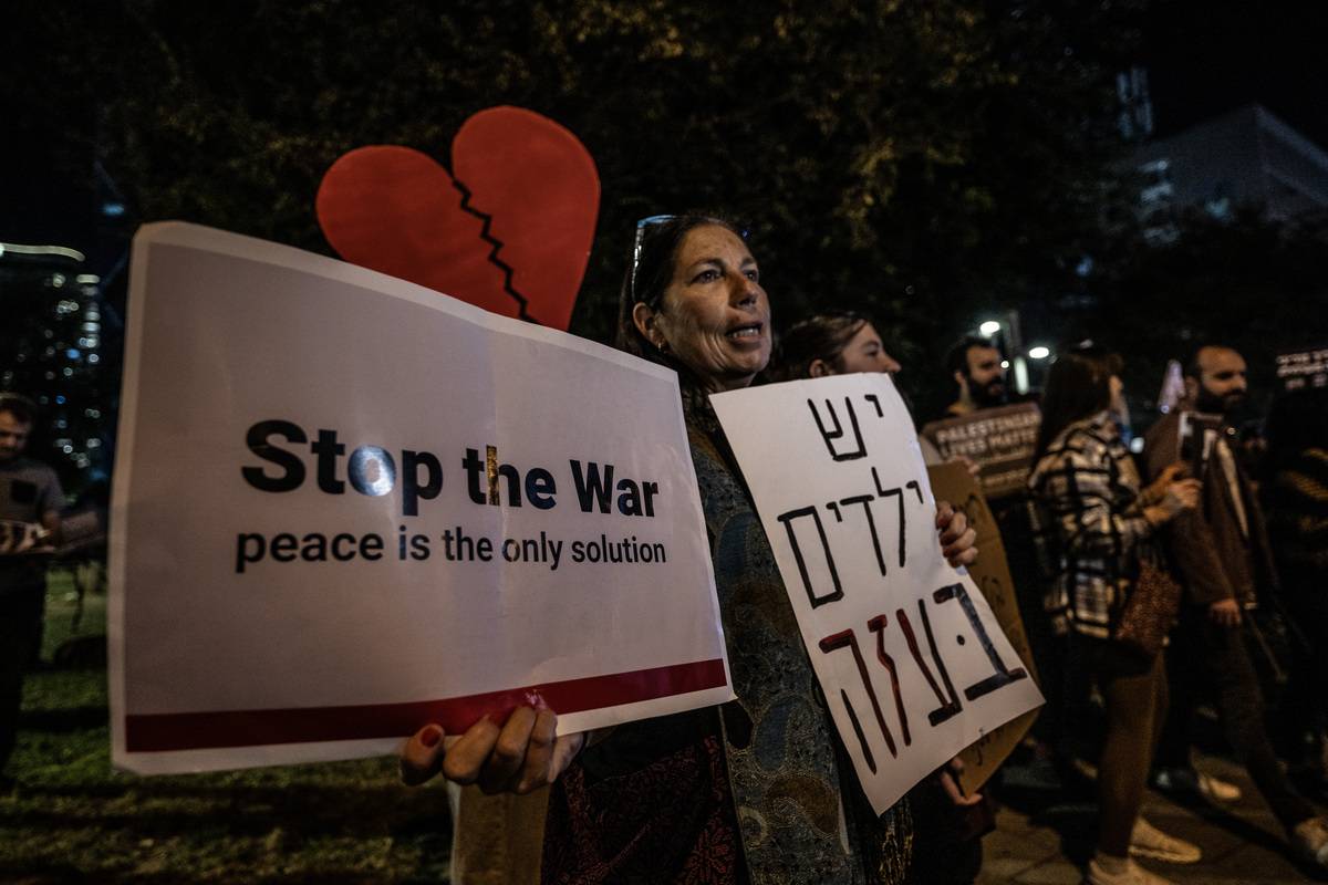 Jewish activists, holding banners, gather to stage an anti-war demonstration in front of the Defense Ministry building in Tel Aviv, Israel on January 06, 2024. [Mostafa Alkharouf - Anadolu Agency]
