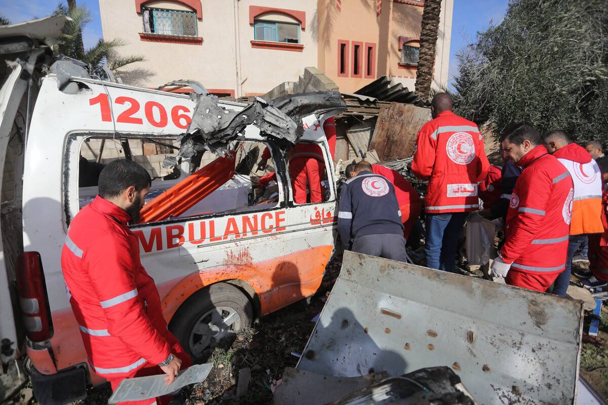 Medical personnel inspect the wreckage of the ambulance after the Israeli army's attack targeted on Wednesday in Deir al-Balah, Gaza, on January 11, 2024. [Ashraf Amra - Anadolu Agency]