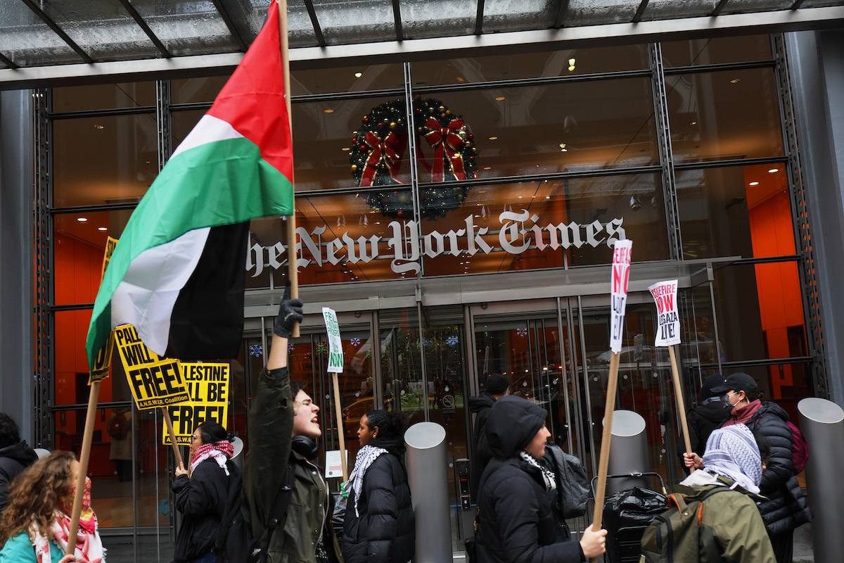 Pro-Palestinian protestors gather outside of the New York Times building to protest the newspaper’s coverage of the Israel-Hamas war on December 11, 2023 in New York City. [Michael M. Santiago/Getty Images]