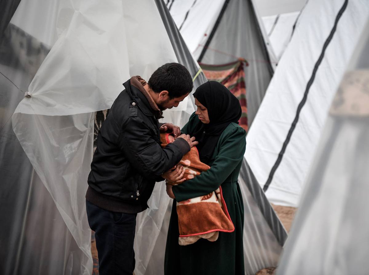 A Gazan mother, Sabreen al-Azami, who was displaced from Beit Lahia city when she was 7 months pregnant due to Israeli attacks and took refuge in a tent, is seen holding her daughter Sukkar on her arms in Rafah, Gaza on December 23, 2023. The mother and her baby born a week ago live in the tent under difficult conditions with health problems. [Abed Zagout/Anadolu via Getty Images]