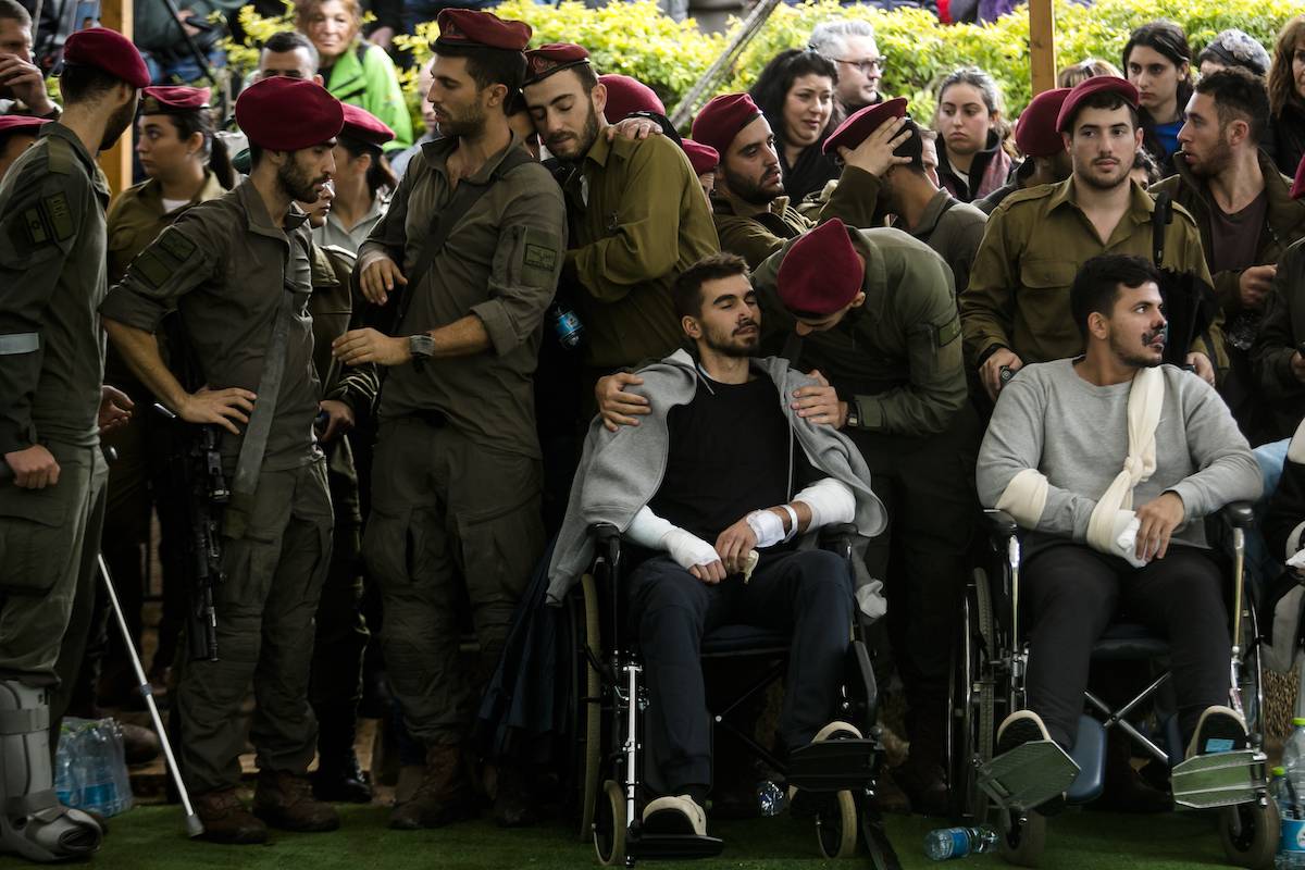 Soldiers, friends from the unit, some of them injured from the battle in Gaza, attend the funeral for Master Sgt. Daniel Weidenbaum on January 14, 2024 in Ra'anana, Israel. [Amir Levy/Getty Images]