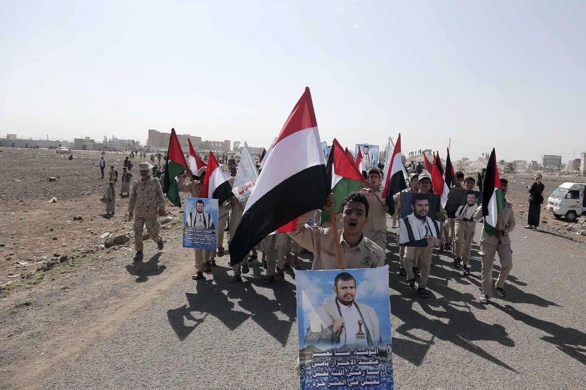 Cadet, carrying banners and flags, attend a graduation ceremony for cadet, completed their military training under the name of "Aqsa Flood", organized by the Houthis, in Arhab district of Sana'a, Yemen on February 4, 2024. [Mohammed Hamoud - Anadolu Agency]