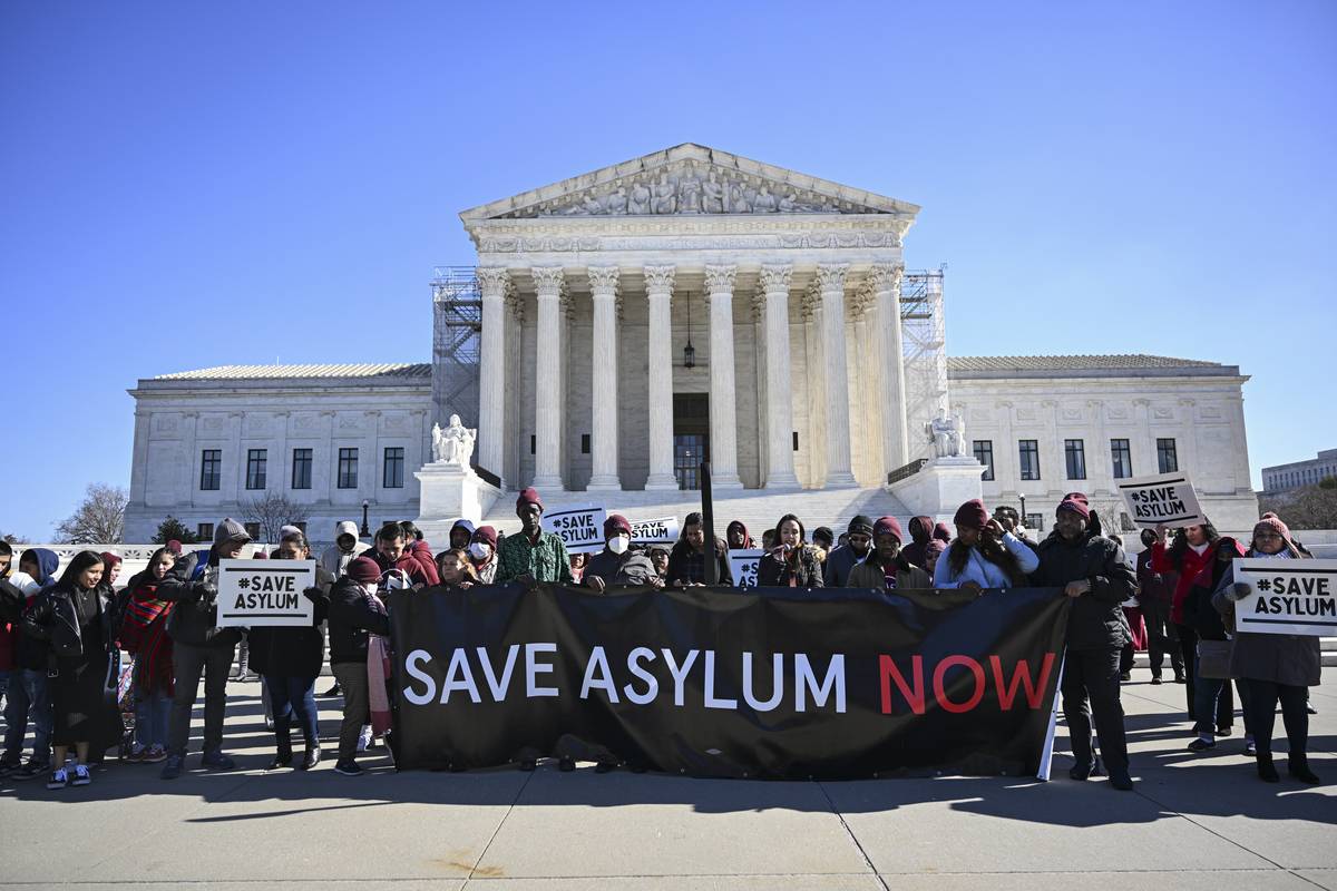 Demonstrators hold "Save Asylum" banners outside the US Supreme Court during a news conference rally in Washington DC., United States on February 6, 2024. [Celal Güneş - Anadolu Agency]