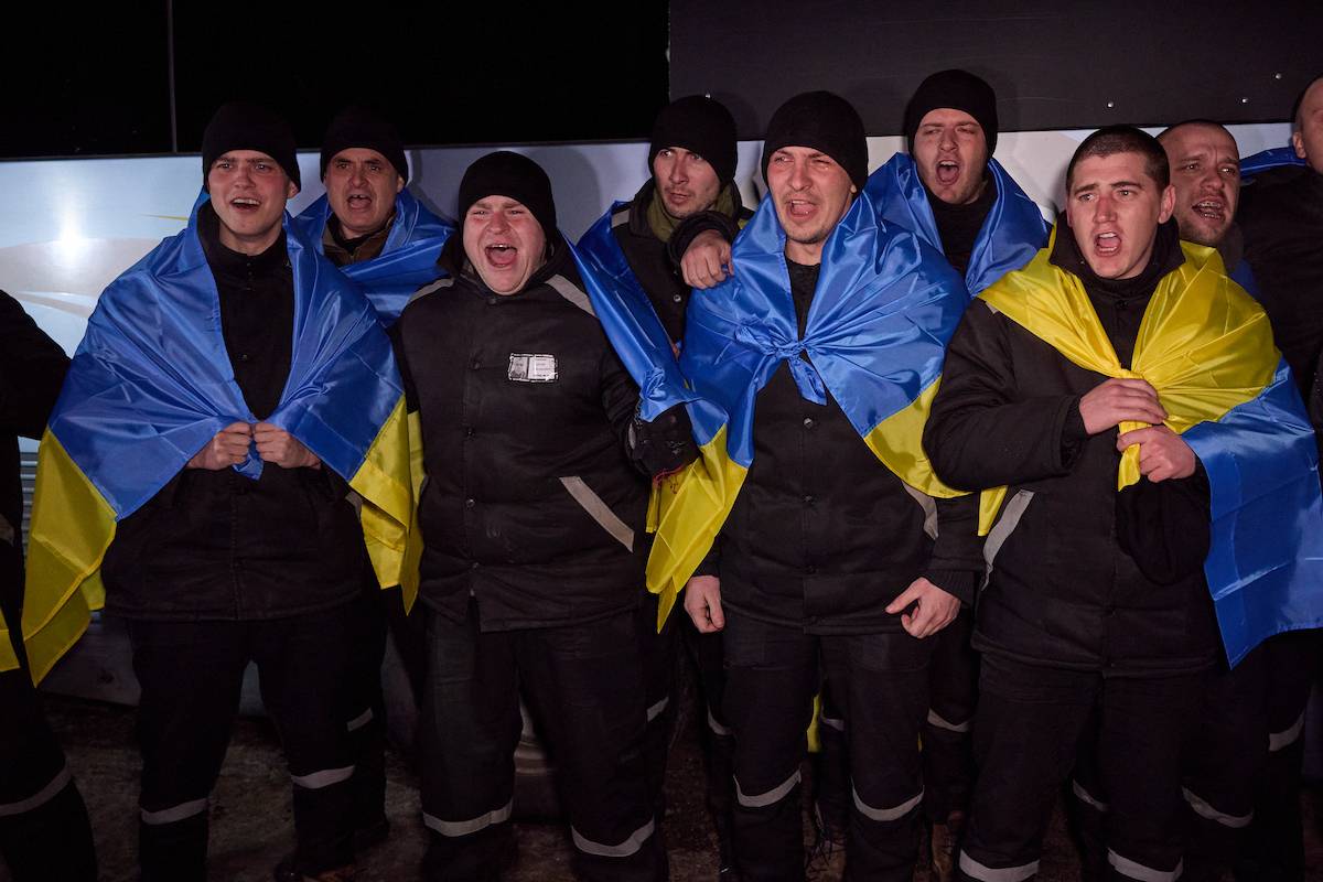 Released Ukrainian servicemen who return to home with bus, pose for a photo with Ukrainian flags in front of the bus as Russia and Ukraine exchanged 100 prisoners of war from each side Thursday through mediation by the United Arab Emirates (UAE), according to the Russian Defense Ministry in Kyiv, Ukraine on February 08, 2024. [Ukrainian Presidency - Anadolu Agency]
