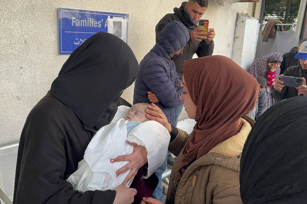 Relatives of Palestinians killed during the Israeli attack mourn as their bodies are taken from al-Najjar hospital morgue for burial in Rafah, Gaza on February 12, 2024. [Doaa Albaz - Anadolu Agency]