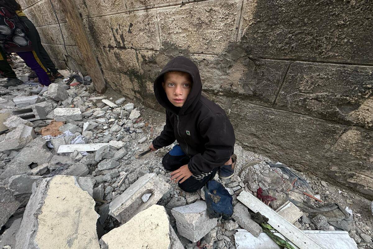 Palestinians, including children, look at the heavily damaged buildings belongings Azira and Zahir families, part of which collapsed, after Israeli attacks in Rafah, Gaza on February 12, 2024.[Doaa Albaz - Anadolu Agency]
