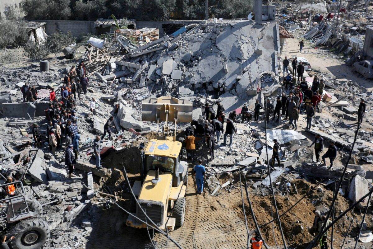An aerial view of the civil defence teams and Palestinians conduct search and rescue operations among the rubbles of the destroyed buildings after Israeli attacks on the house belonging to the Reyyan family as Israel's air, land and sea attacks continue on the Gaza Strip at Nuseirat refugee camp in Deir al-Balah, Gaza on February 15, 2024 [Ashraf Amra - Anadolu Agency]