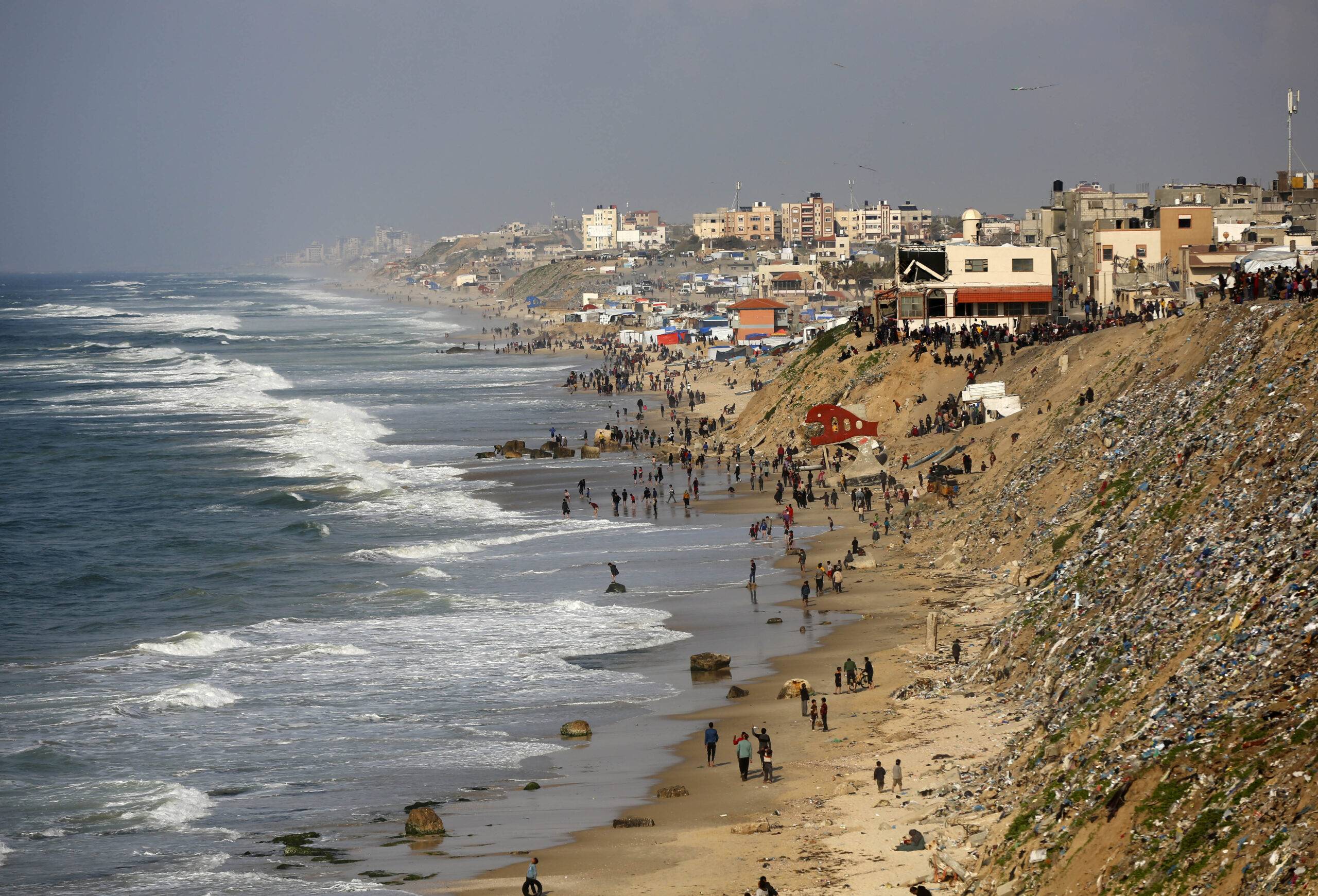 Palestinians wait for humanitarian aid airdrop at the beach in Deir al Balah, Gaza on February 27, 2024. [Ashraf Amra - Anadolu Agency]