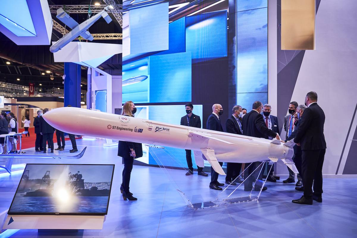 Visitors stand next to a model of the Blue Spear land-to-sea missile system, developed by Proteus Advanced Systems Pte. Ltd., a joint venture company of Israel Aerospace Industries Ltd. (IAI) and ST Engineering Land Systems Ltd., at the Singapore Airshow held at the Changi Exhibition Centre in Singapore, on Tuesday, Feb. 15, 2022. [SeongJoon Cho/Bloomberg via Getty Images]