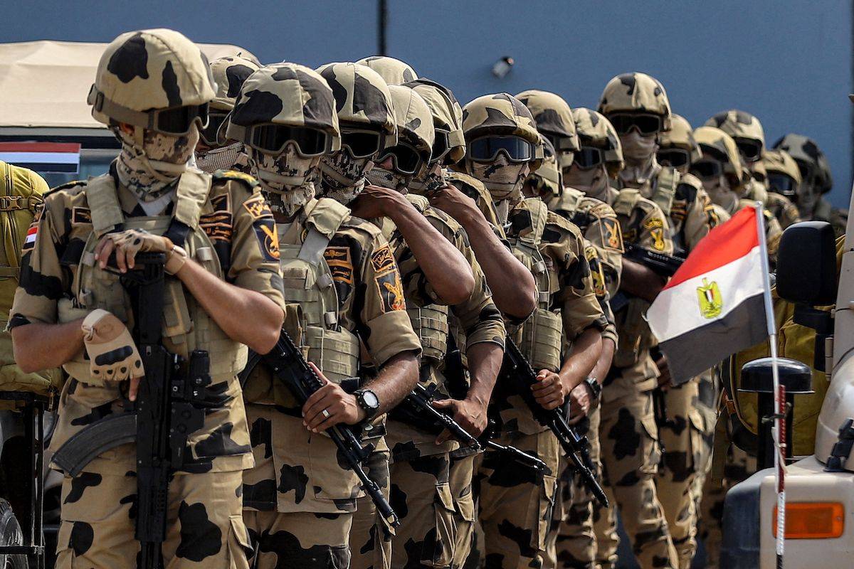 Egyptian army special forces soldiers deploy before the concrete barrier marking the border between Egypt and the Gaza Strip in Rafah in the east of North Sinai province on October 20, 2023 during a visit there by the United Nations secretary-general to oversee preparations for the delivery of humanitarian aid to the war-torn Palestinian enclave. [KEROLOS SALAH/AFP via Getty Images]