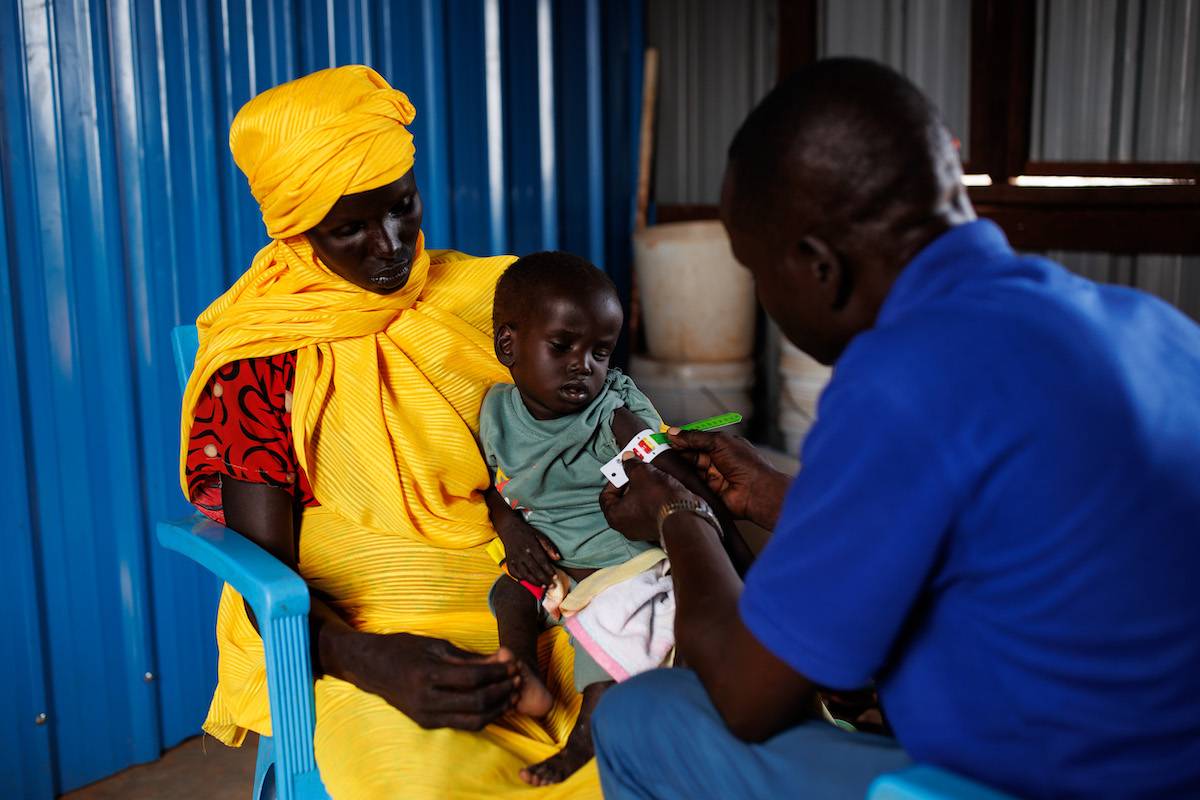 A young boy recovering from measles is bought into a clinic by his mother for MUAC measurements on November 29, 2023 in Rotriak, South Sudan. The young boy was found to have Severe Acute Malnutrition [Luke Dray/Getty Images]