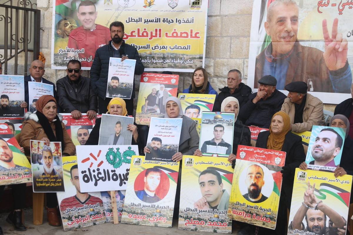 Palestinians, holding banners and photos of their relatives, gather to stage a demonstration on demanding release of the Palestinian prisoners in Israeli jails in front of International Committee of the Red Cross (ICRC) building in Ramallah, West Bank on January 02, 2024. [Issam Rimawi/Anadolu via Getty Images]