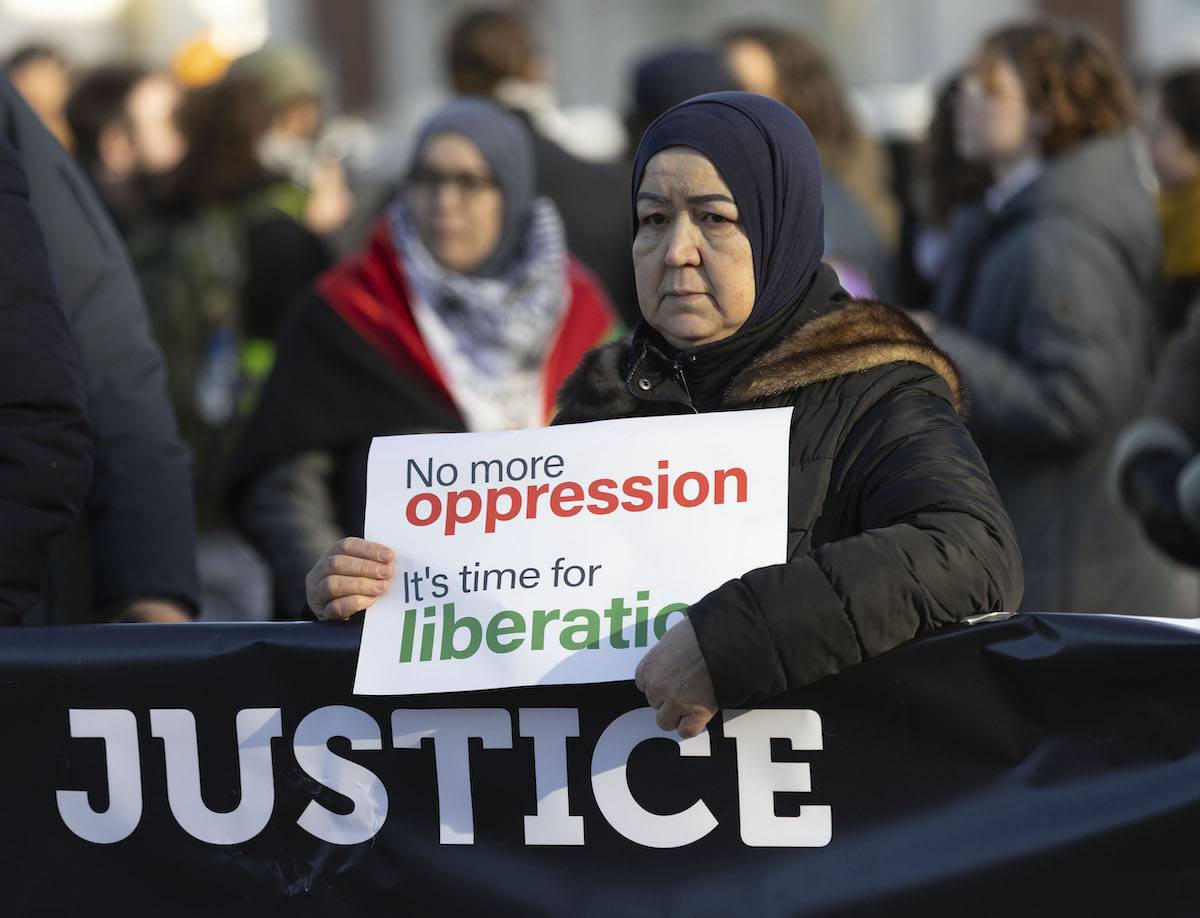 A Pro Palestinian protester stands outside the International Court of Justice (ICJ) prior to the ICJ's order on South Africa's genocide case against Israel on January 26, 2024 in The Hague, Netherlands. [Michel Porro/Getty Images]