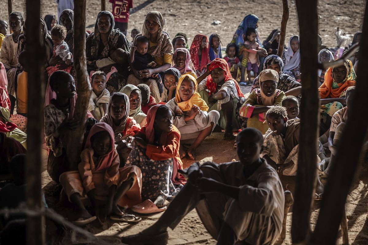 Sudanese refugees and ethnic South Sudanese families who have fled from the war in Sudan gather after crossing the border while waiting to be registered by the authorities at the Joda Border Crossing Point, near Renk, on February 14, 2024. [LUIS TATO/AFP via Getty Images]