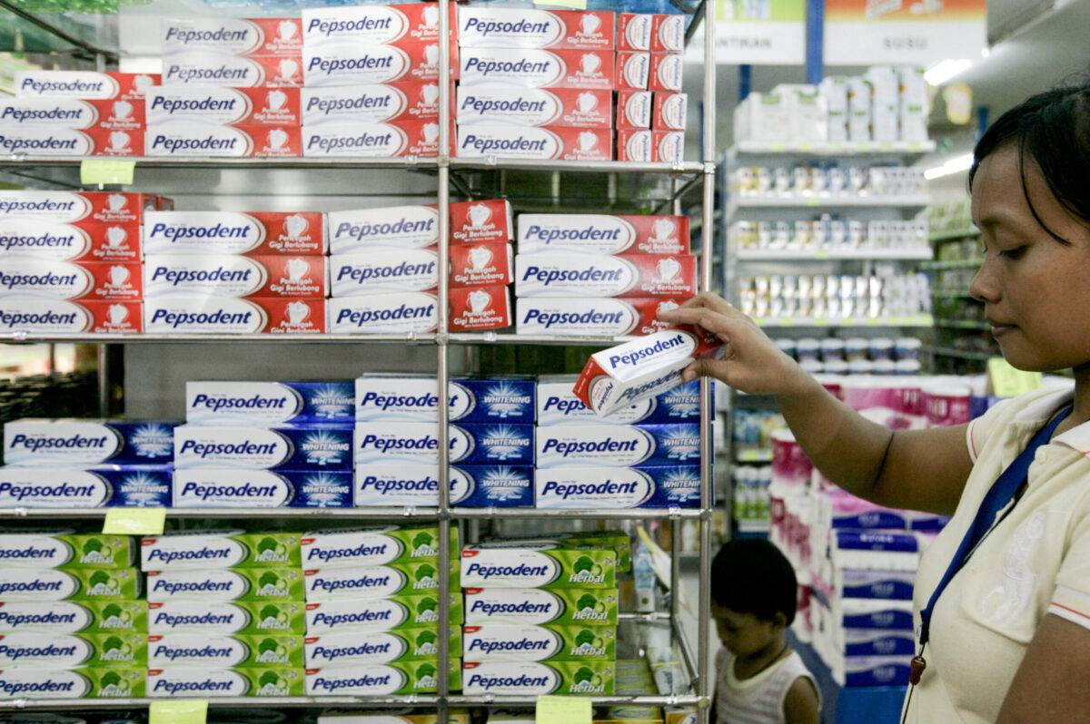 A shopper buys Pepsodent tooth paste, a product of PT Unilev
