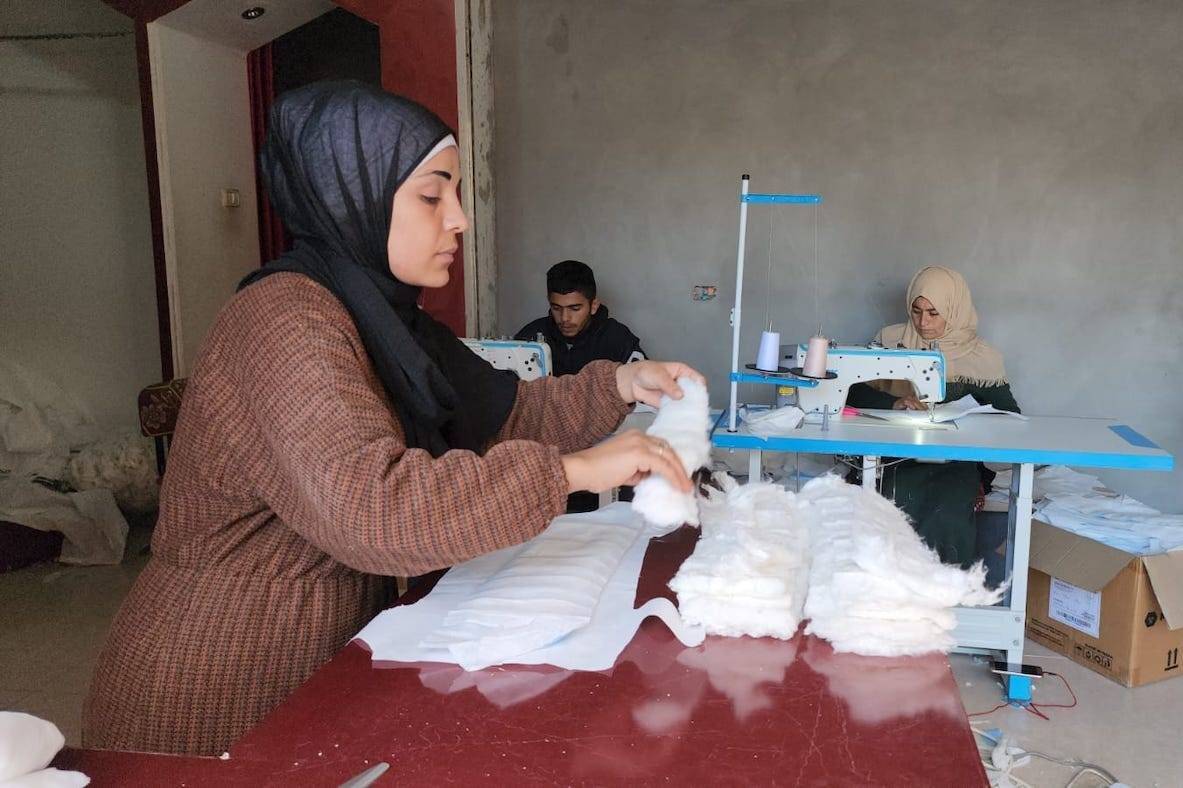 A group of Palestinian women build a small workshop to sew nappies in Gaza [Wafa Aludaini]