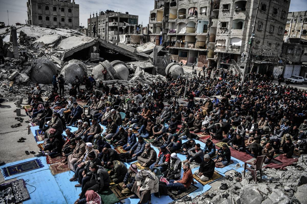 An aerial view of Palestinians performing Friday prayers among the rubble of the Al-Farooq Mosque, destroyed in an Israeli attack on March 01, 2024 in Rafah, Gaza. [Abed Zagout - Anadolu Agency]