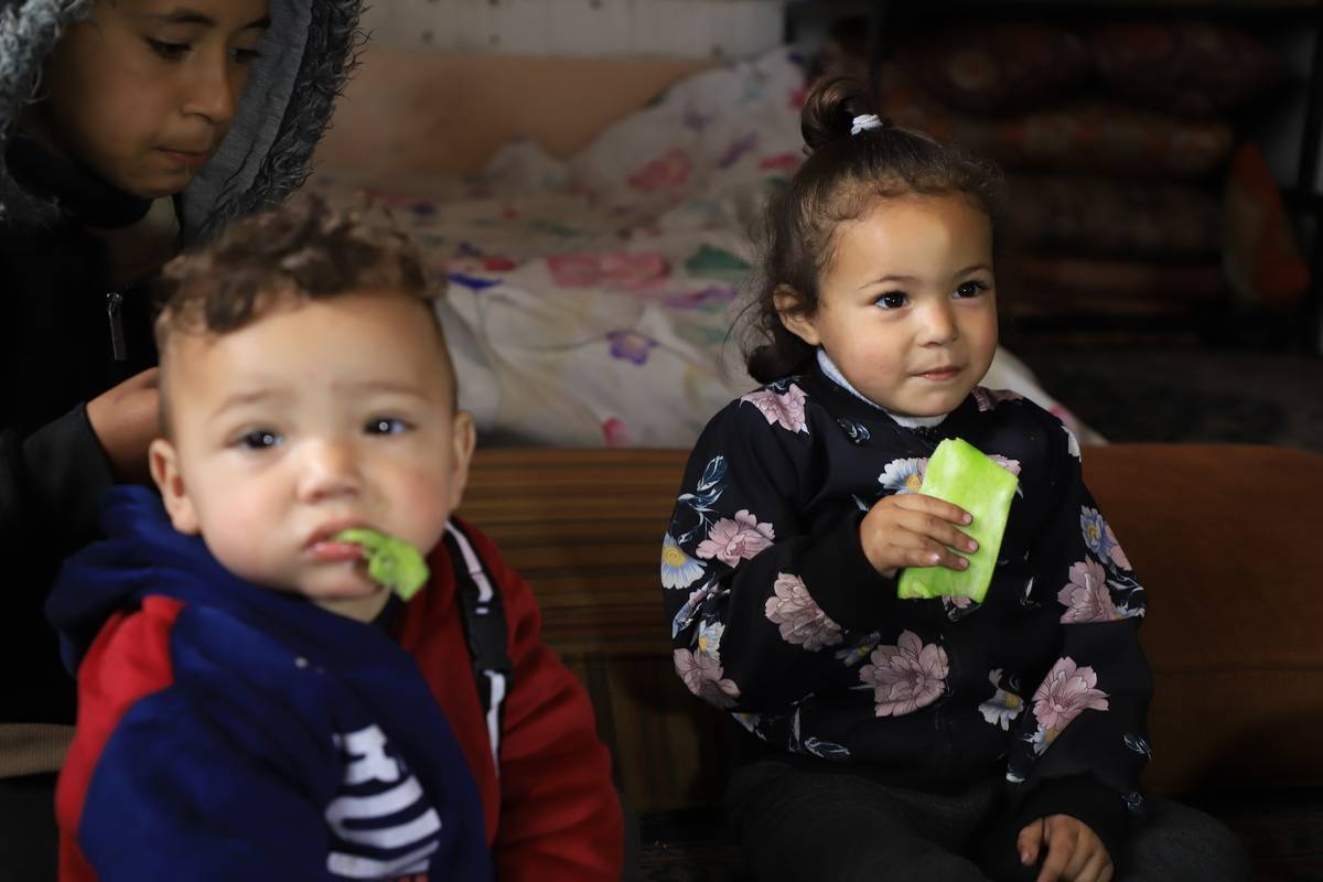Oweida family eat cactus leaves as they struggle to find food due to ongoing Israeli blockade as they take refuge in a UNRWA school, seeking safety amid Israeli attacks in Beit Lahia, Gaza on February 28, 2024. [Mahmud Isa - Anadolu Agency]