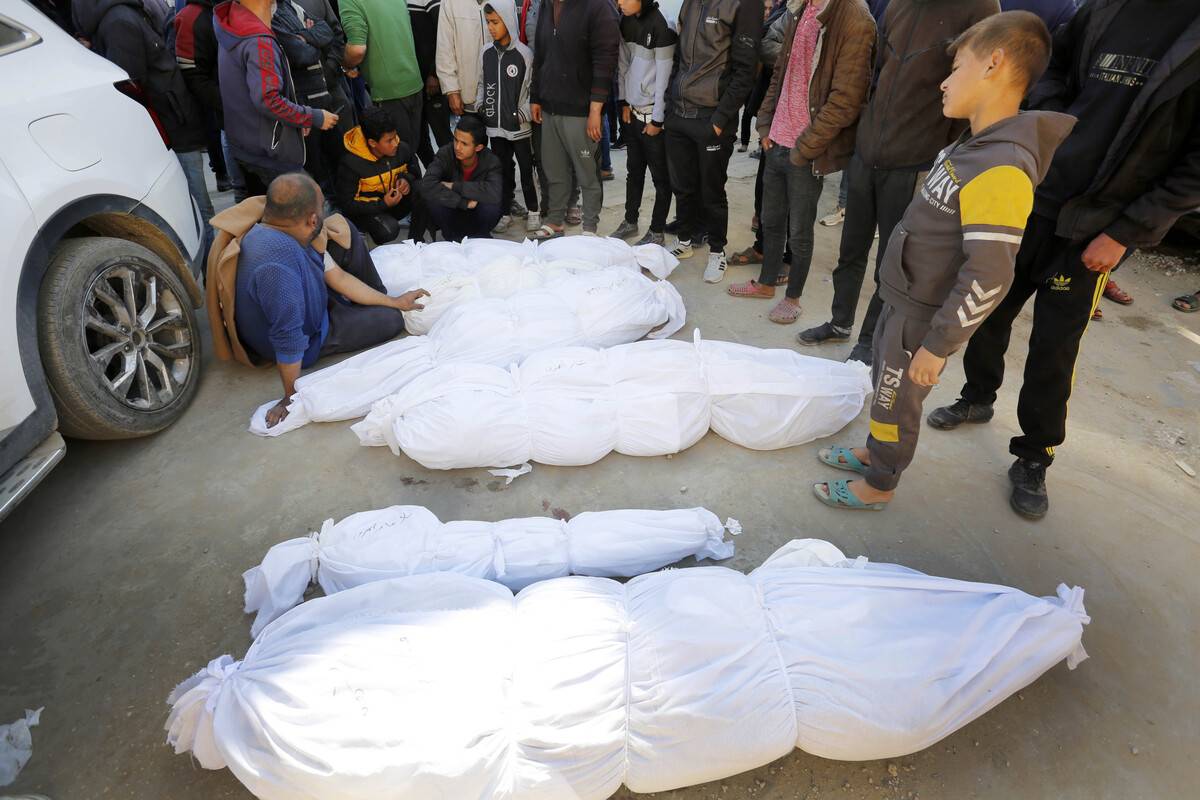 Relatives mourn near dead bodies of Palestinians collected from the morgue of Al Aqsa Hospital to be buried as Israeli attack hit the apartment of Palestinian Al Yazuri family killing and injuring family members in Deir Al Balah, Gaza on March 12, 2024. [Ashraf Amra - Anadolu Agency]
