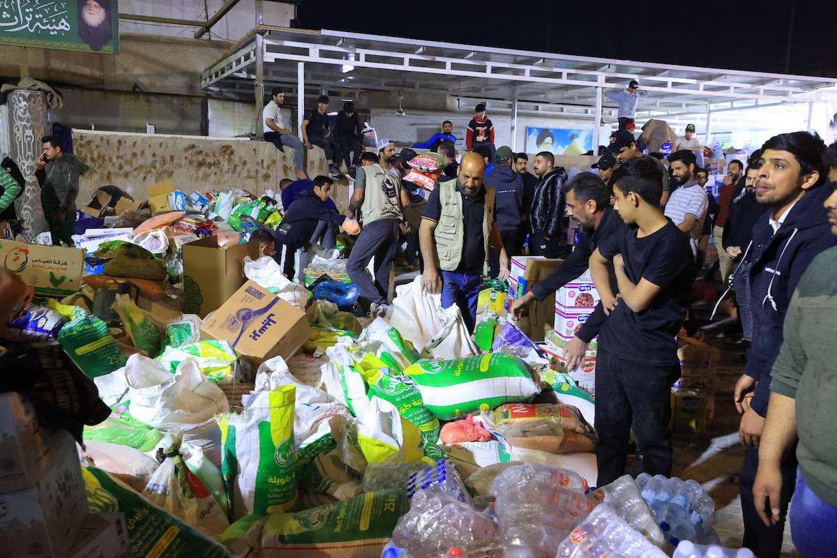 A group of volunteers collects humanitarian aid to be sent to Gaza due to the ongoing Israeli offensive and blockade on Palestinians, in Baghdad, Iraq on March 13, 2024. [Murtadha Al-Sudani - Anadolu Agency]