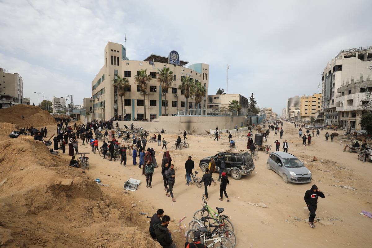 Palestinians gather in front of UN agency for Palestinian refugees (UNRWA) building to receive the 5 kg flour aid as the first humanitarian aid convoy in months has entered Gaza amid Israeli attacks in Jabalia, Gaza on March 17, 2024. [Dawoud Abo Alkas - Anadolu Agency]