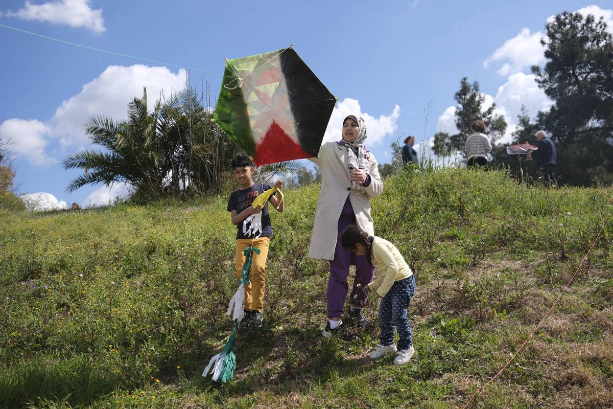 Greek and Palestinian citizens prepare their kites for an event called "A kite for a free Palestine" to send a message of support to the Palestinian people in Athens, Greece on March 18, 2024. [Aggelos Barai - Anadolu Agency]