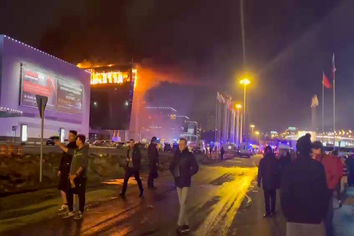 A screen grab from a video shows smoke rises from fire as ambulances, personnel arrive at Crocus City Hall concert venue near Moscow, Russia after reports of a shooting incident on March 22, 2024. [Ali Cura - Anadolu Agency]
