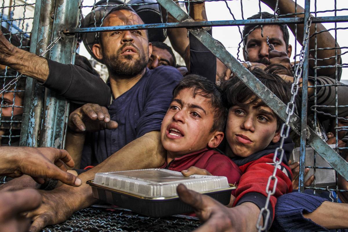 Crowd of starving Palestinians, including children, wait to receive food distributed by charity organizations amid Israel's blockade as the situation dramatically deteriorates in Jabalia refugee camp, Gaza on March 27, 2024. [Mahmoud Issa - Anadolu Agency]